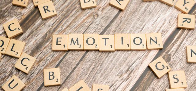 scrabble tiles spelling the word emotion on a wooden surface by Markus Winkler courtesy of Unsplash.